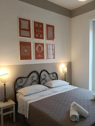 a bedroom with a large bed with two lamps and a bedspread at B&B Liberty in Andria