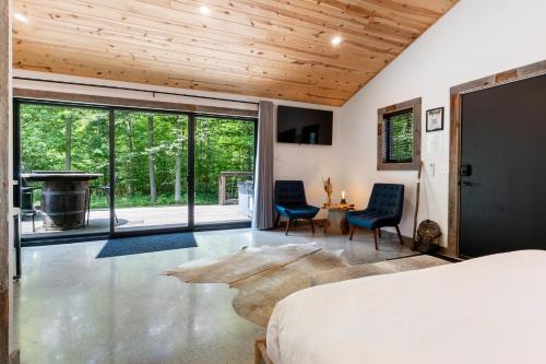 a bedroom with a bed and a large window at Standing Rock Farms in Madison