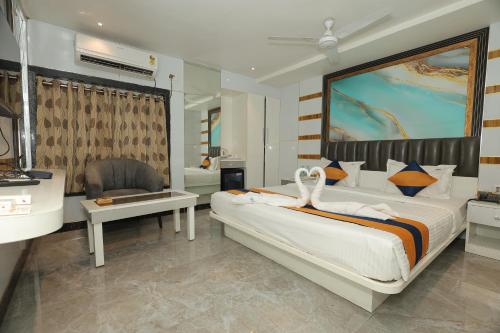 a bedroom with a large bed and a bathroom at N S International in Kolkata