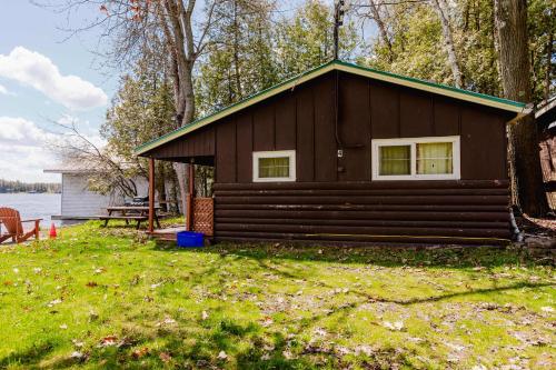 a cabin on the shore of a body of water at Ambleside - 2-Bedroom Cottage #4 in Kawartha Lakes