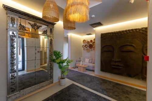 a bathroom with a large carving of a face on the wall at Cesme Sarezya Luxury Boutique Hotel in Çeşme