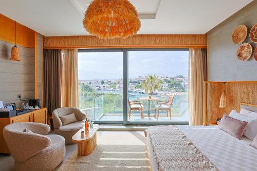 a bedroom with a bed and a table and chairs at Cesme Sarezya Luxury Boutique Hotel in Çeşme