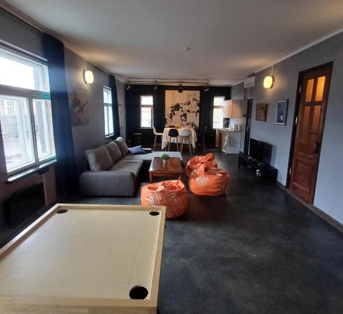 a living room with a couch and a table at Objekts Guesthouse - Creative Quarter Apartment in Riga