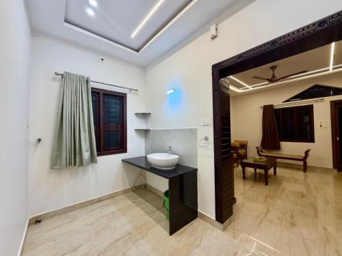 a bathroom with a sink in a room at Tri Riverfront Homestay in Udupi