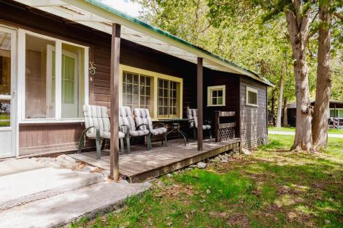 a house with a porch with chairs on it at 3-Bedroom Cottage #7 - Ambleside in Kawartha Lakes