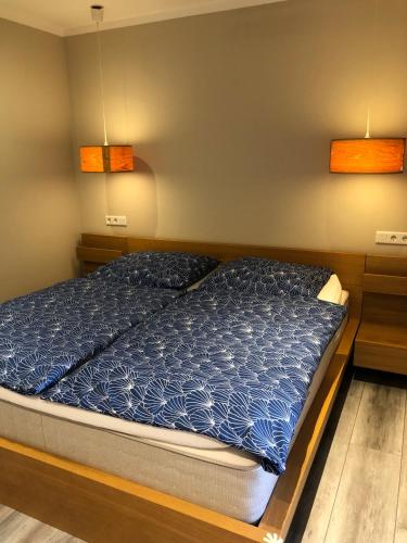 a bedroom with a bed with blue comforter at Emmerglück Lügde in Lügde