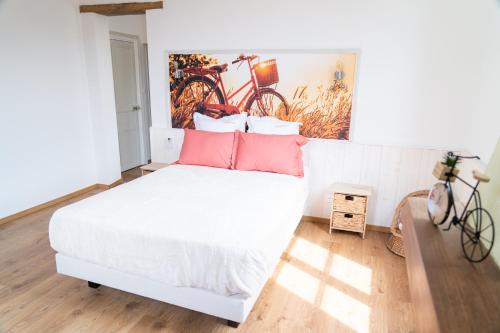a bedroom with a bed with two bikes on the wall at Parnaydisiaque in Parnay