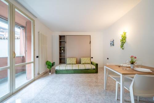 a living room with a table and a couch at Lake Como - Front Station - Lake at 2 min - Wifi in Lecco