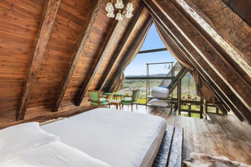 a bedroom in a tree house with a bed and a table at Sunrise House - Swimming Pool in Berat