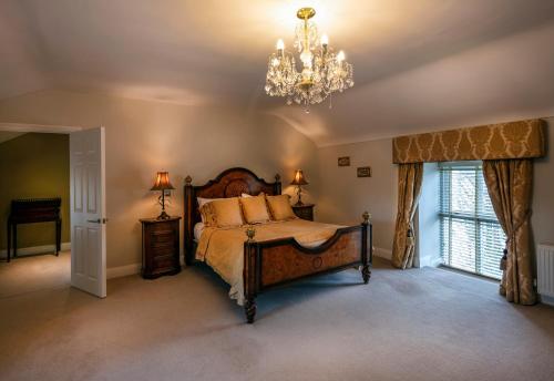 a bedroom with a bed and a chandelier at Moyvalley Hotel & Golf Resort in Enfield