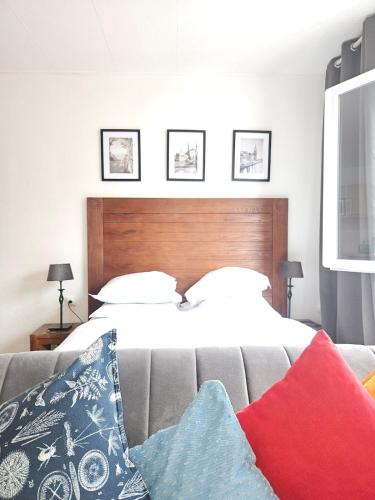 a bedroom with a bed and a couch with pillows at Le 61 Roosvelt in Amiens
