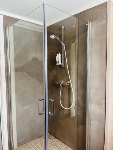 a shower with a glass door in a bathroom at Large cabin with panoramic wiews in Ål, Hallingdal in Al