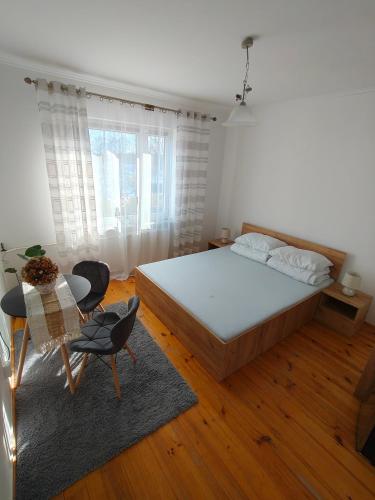 a bedroom with a large bed and a table at Agroturystyka Krzywy Zakątek in Krzywe