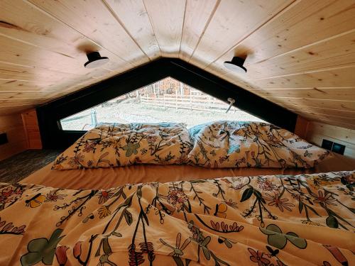 a large bed in a room with a large window at Čiles in Kostolec