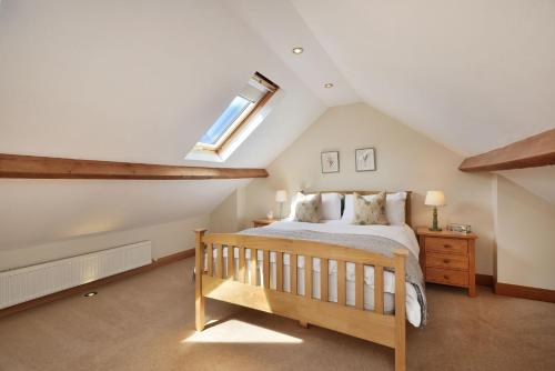a attic bedroom with a bed and a skylight at Spacious Free Parking 5 Mins from City Centre in Hereford