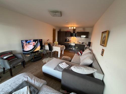 a living room with a couch and a tv at Helle Wohnung in Fürth in Fürth