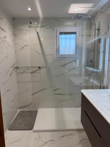 a bathroom with a shower with a glass door at Villa sainte maxime golfe de Saint Tropez in Sainte-Maxime
