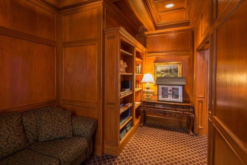 a living room with a couch and a piano at Fort Harrison State Park Inn in Indianapolis