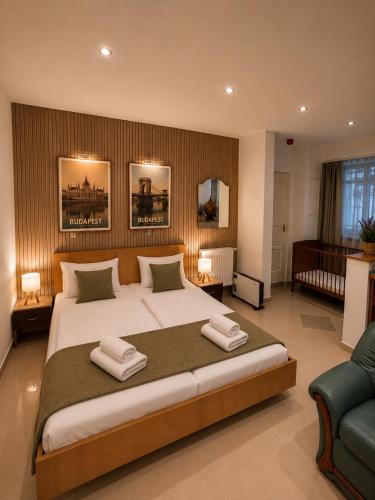 a bedroom with a large bed with two towels on it at Esprit Residences Budapest in Budapest