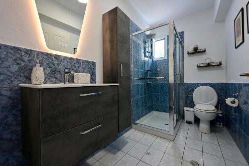 a bathroom with a sink and a toilet and a shower at Agrielia House in Alonnisos