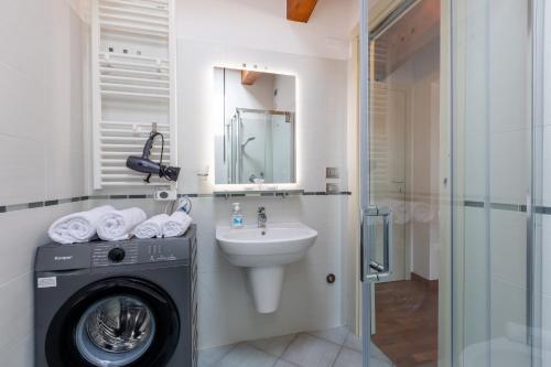 a bathroom with a washing machine and a sink at AcquaRoom in Montesilvano Marina