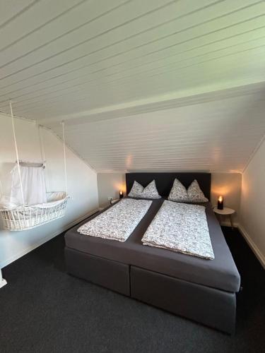 a bedroom with a large bed in a attic at Ferienhaus Luisl & Hilde in Unterammergau
