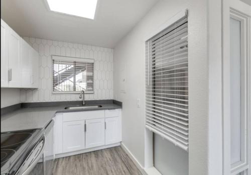 a white kitchen with a sink and a window at Close to ASU campus in Tempe