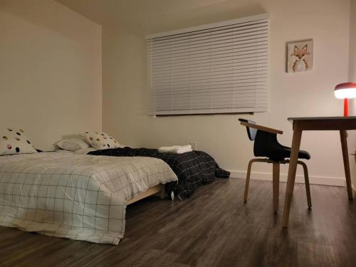 a bedroom with a bed and a desk and a chair at Close to ASU campus in Tempe