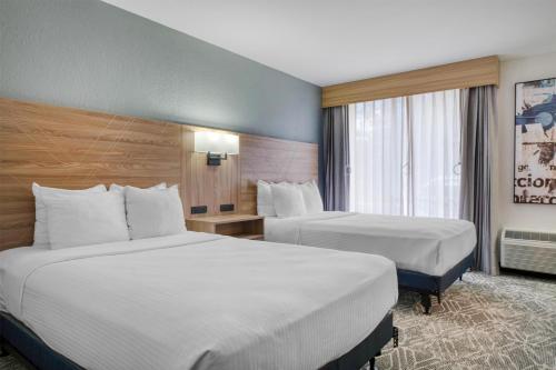 a hotel room with two beds and a window at Best Western Tomah Hotel in Tomah