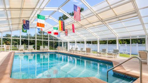 a swimming pool with flags in a building at Colonial Acres Resort in Yarmouth