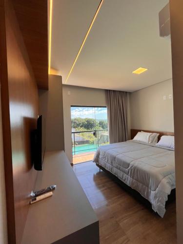 a hotel room with a bed and a balcony at Cascata Boutique Hotel in Várzea da Palma