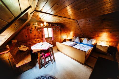 an overhead view of a bedroom with a bed and a table at Almhütte am Steirischen Seeberg in Turnau