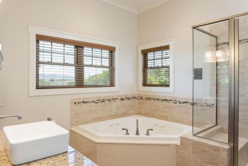 a white bathroom with a tub and a glass shower at Massanutten Resort in Massanutten