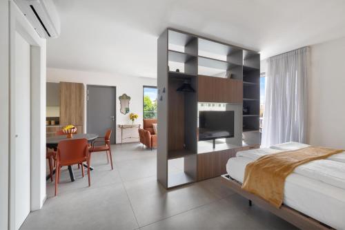 a bedroom with a bed and a dining room at La Casetta di Cannero by Residenza La Zagara in Cannero Riviera