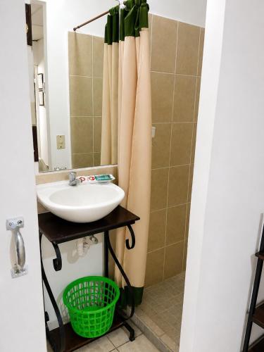 a bathroom with a sink and a mirror at Orison Managua in Managua