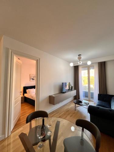 a living room with a couch and a table at Mare Sea View Suites ,One Bedroom 305 in Bečići