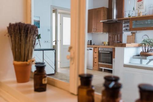 a kitchen with wooden cabinets and a counter top with bottles at Historisches Bürgerhaus Hartlschuster in Neufelden