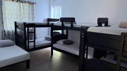 a room with three bunk beds and a window at Finca Santa Rita in Pereira