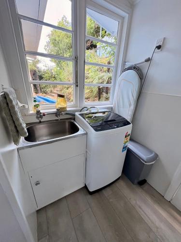a small kitchen with a sink and a window at Windy Garden in Marahau