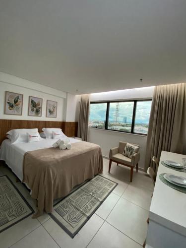 a bedroom with a bed and a chair and a window at AliReserva Luxury Suites in Palmas