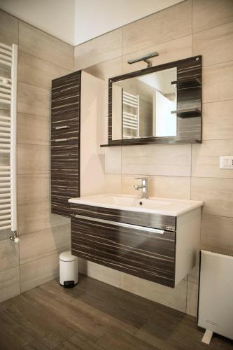 a bathroom with a sink and a mirror at La Loggia, Historic Center in Grottaglie