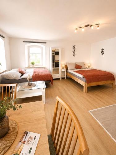 a large room with two beds and a table at Haus Erna Weitra in Weitra