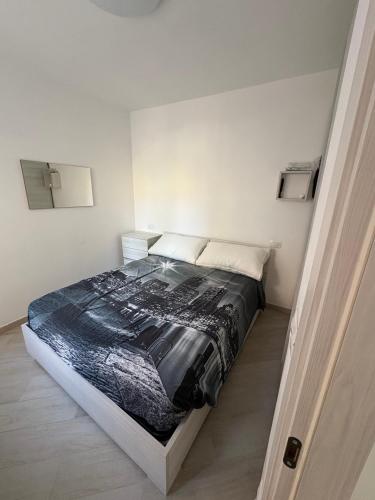 a bedroom with a bed in a white room at Appartamenti Flora in Castelsardo