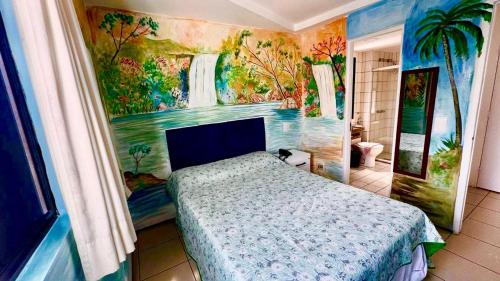 a bedroom with a bed and a painting on the wall at Praia Mansa Suite Hotel Flat in Fortaleza