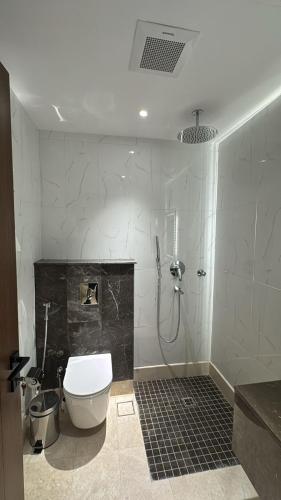a bathroom with a shower and a toilet in it at نون Noon in Medina
