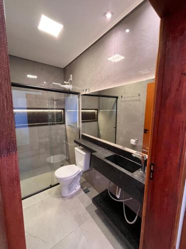 a bathroom with a toilet and a sink at Cascata Boutique Hotel in Várzea da Palma