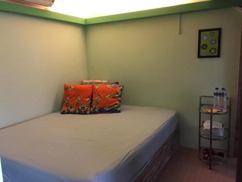 a room with a bed with a pillow on it at A-HOME in Jiufen