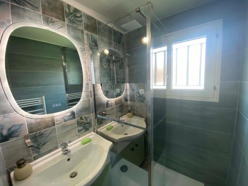 a bathroom with a sink and a mirror at MAISON les ARCADES in Soustons