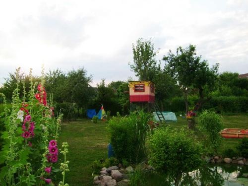 a garden with a pond and a tent in the background at Ferienwohnungen in Semlow in Semlow