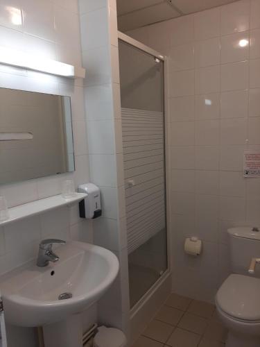 a bathroom with a shower and a sink and a toilet at Stella Maris in Stella-Plage